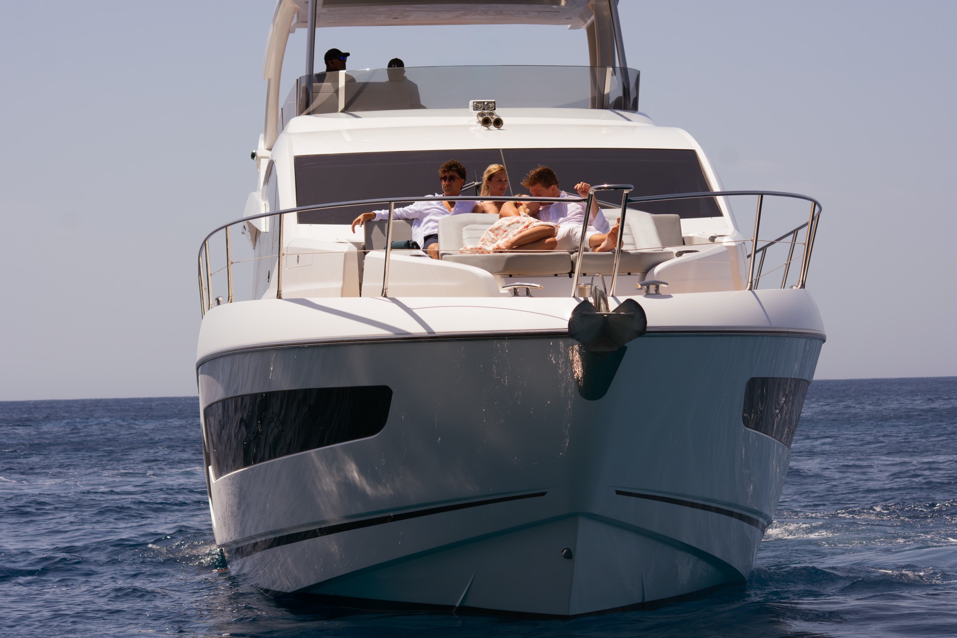 Aerial view of a private yacht running along the Maltese coast at golden hour