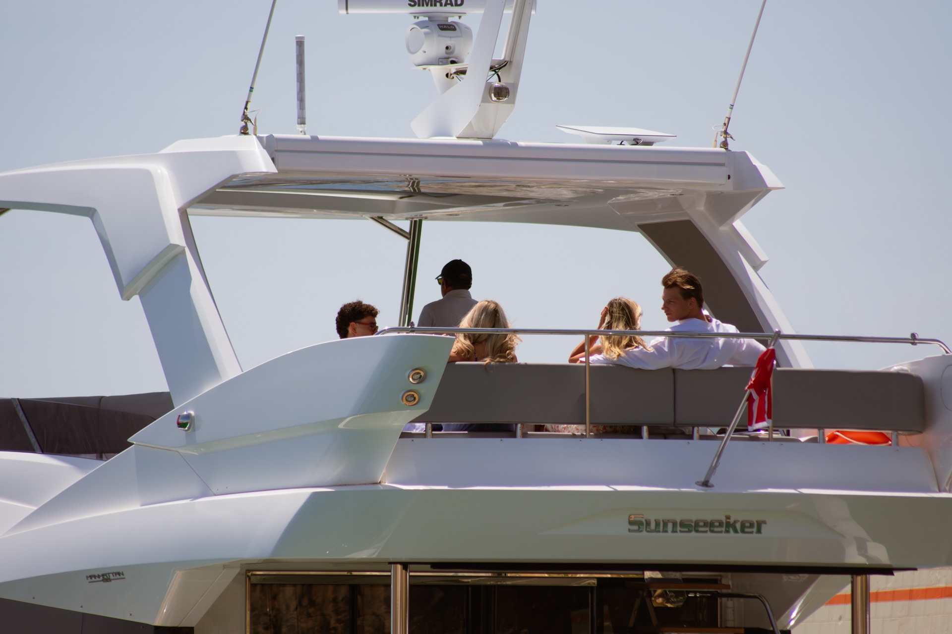 Guests on the flybridge of a charter yacht