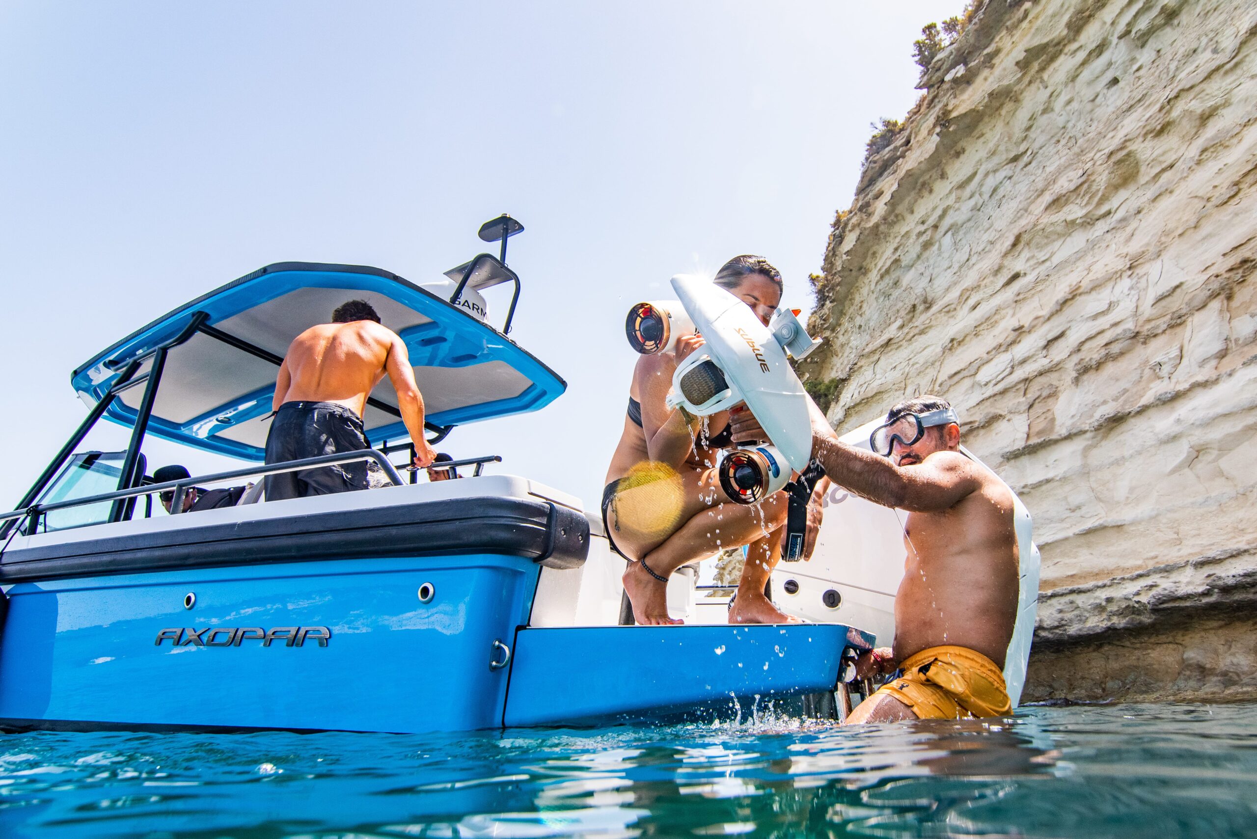 Group near a yacht in a sheltered bay